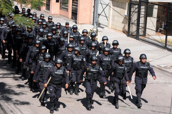 A column of Honduran police in riot gear